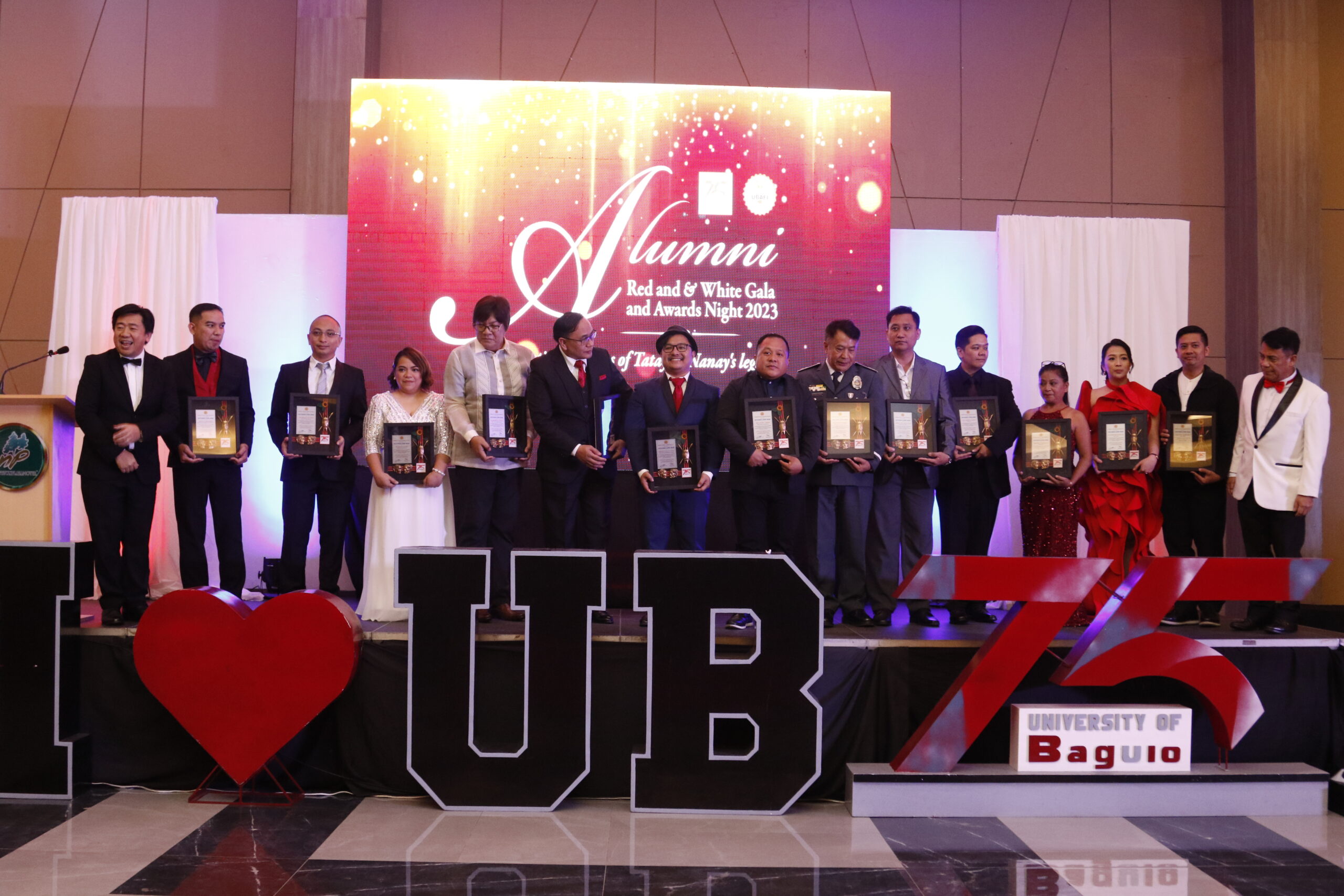 The thirteen Outstanding Alumni awardees posing for a photo with Engr. Javier Herminio Bautista (far left) and Engr. Eleazer Demayo (far right).