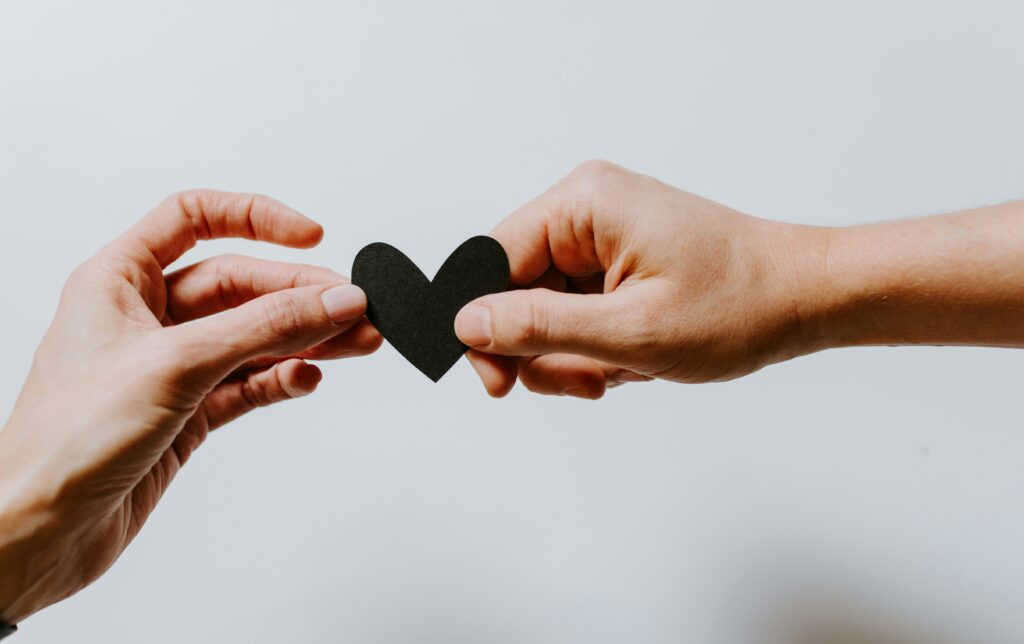 Two Hand in solidarity for mental health. Photo by Kelly Sikkema | Unsplash
